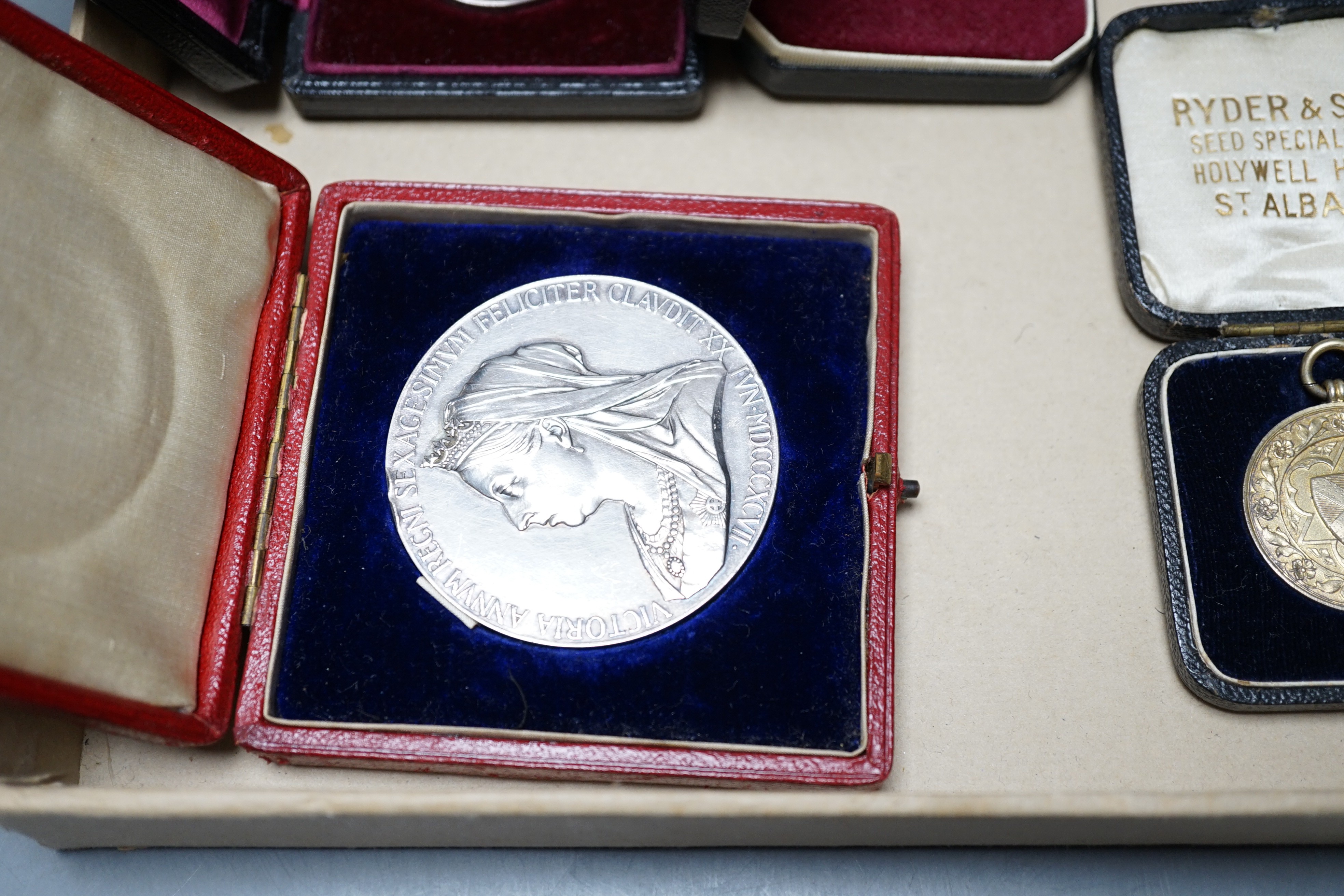 A group of silver commemorative medals, a Victoria 1889 crown, 1880 halfcrown, two cased ISM and to WW1 medals